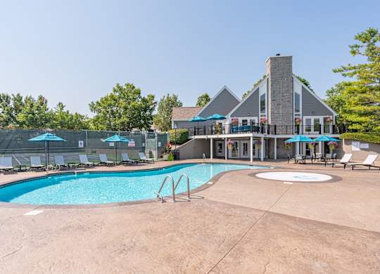A large outdoor swimming pool with a building in the background.