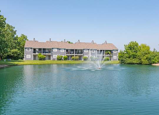 A house with a fountain in front of it.