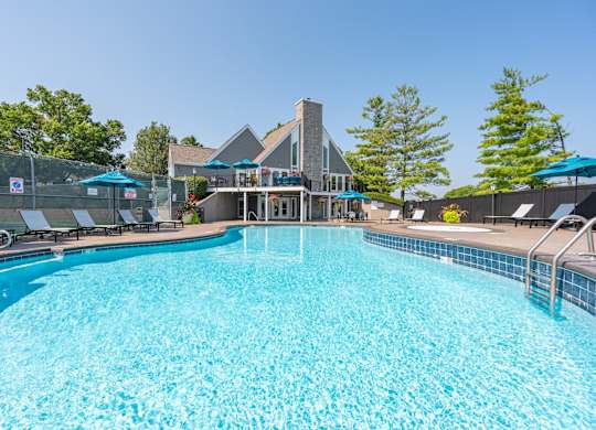 A large swimming pool with a building in the background.