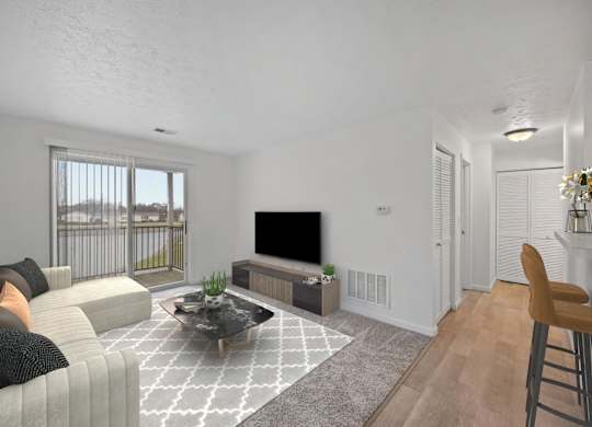 A living room with a grey sofa, a black coffee table, and a television.