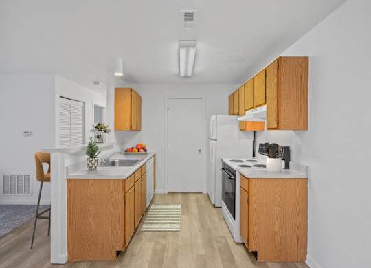 A kitchen with wooden cabinets and white appliances.