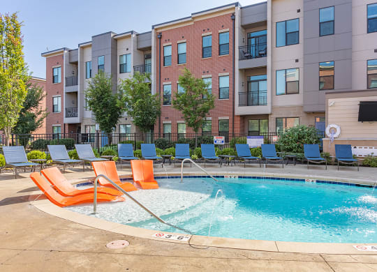 our apartments have a resort style pool with chairs at DeSales Flats Apartments*, Ohio, 45206