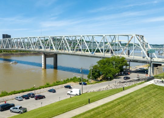 a view of a bridge over the river with cars driving under it