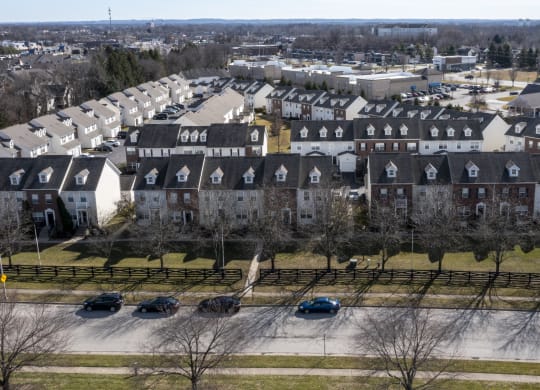 an aerial view of a neighborhood of houses with cars parked at Traditions at Slate Ridge, Reynoldsburg, 43068