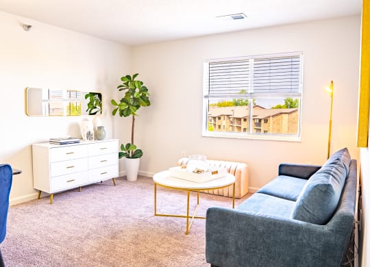 a living room with a couch coffee table and dresser