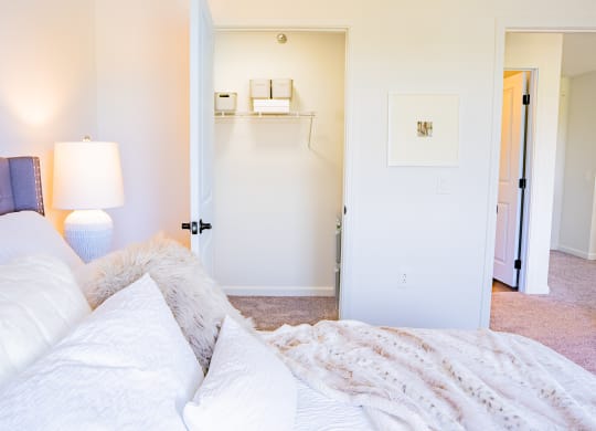 a bedroom with a bed and a lamp