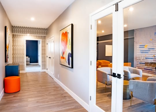 a hallway with white walls and hardwood floors