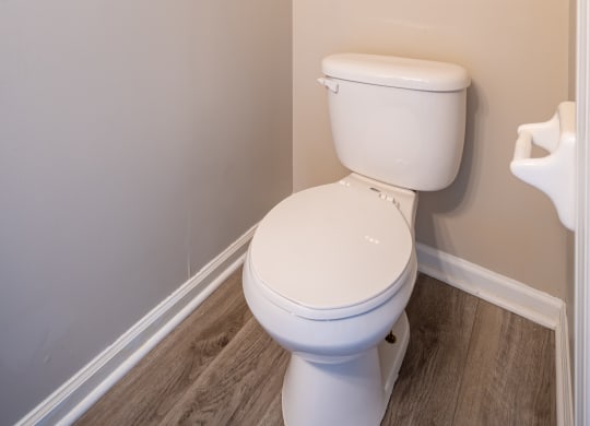 an empty bathroom with a toilet and a grab bar at Traditions at Slate Ridge, Ohio