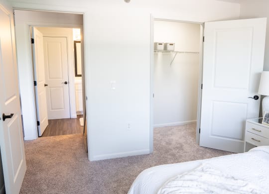 a bedroom with white walls and carpet