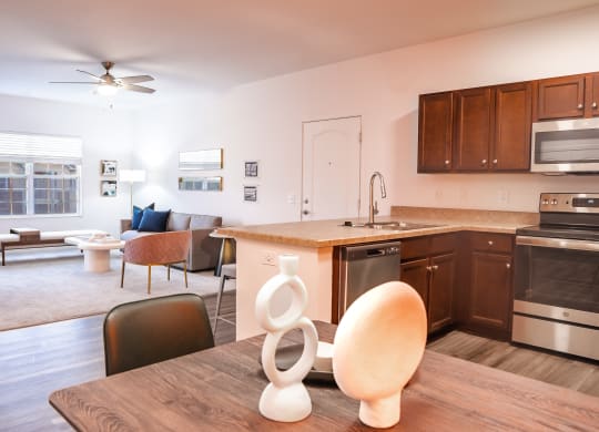 a kitchen and living room with a table and chairs and a ceiling fan  at Waterstone Landing, Perrysburg