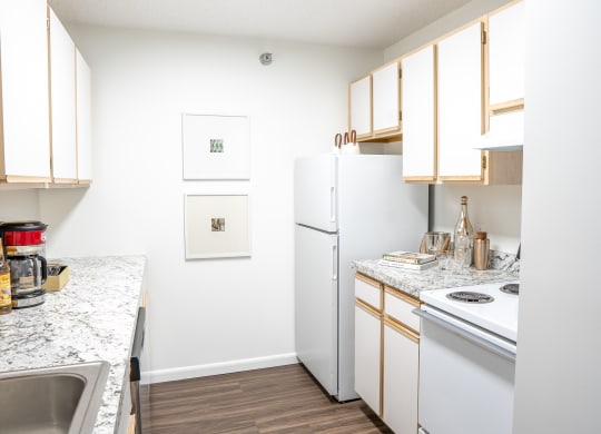 a kitchen with white appliances and wooden cabinets