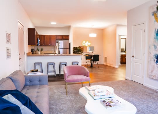 a living area with a couch coffee table and a kitchen in the background  at Waterstone Landing, Perrysburg, Ohio