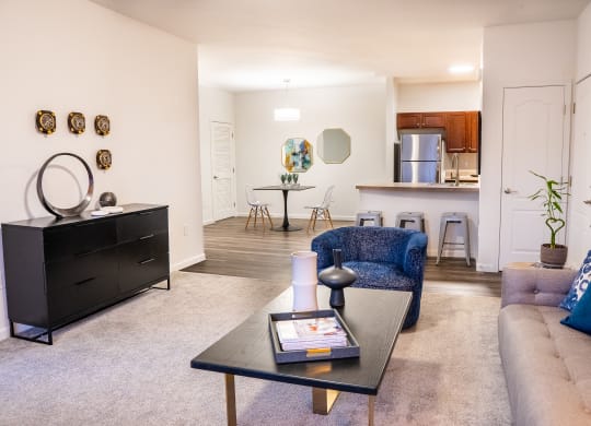 a living room with a couch coffee table and a kitchen in the background at Waterstone Landing, Perrysburg, OH