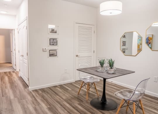 a dining area with a table and chairs and a hallway in the background  at Waterstone Landing, Ohio, 43551