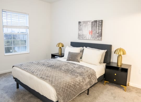a bedroom with a bed and two nightstands with lamps  at Waterstone Landing, Perrysburg