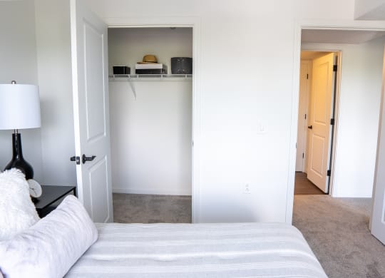 a bedroom with white walls and a white couch