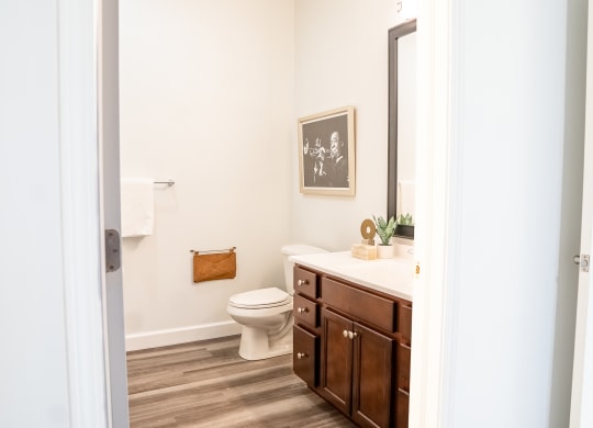 a bathroom with white walls and wood floors  at Waterstone Landing, Ohio, 43551