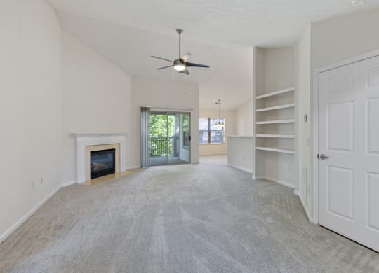 an empty living room with a fireplace and a ceiling fan at Four Bridges, Liberty Township, OH, 45044-8380