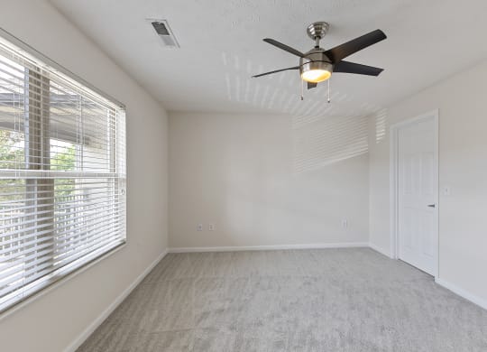 an empty bedroom with a ceiling fan and a window at Four Bridges, Liberty Township, Ohio