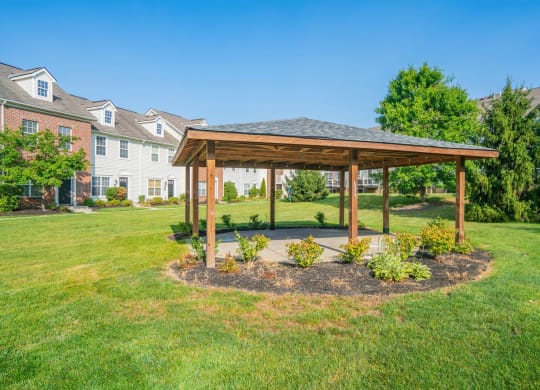 a gazebo in the middle of a yard with houses in the background at Traditions at Slate Ridge, Ohio