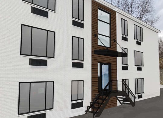 the side of a white building with black windows