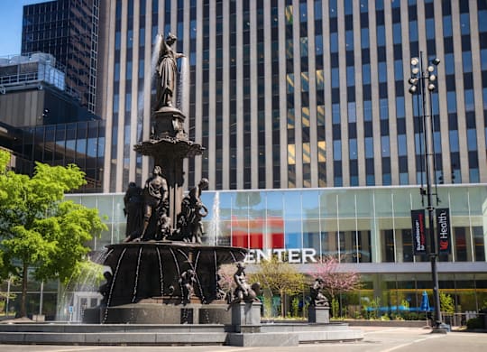 A fountain in front of a building with the word "CENTER" on it.