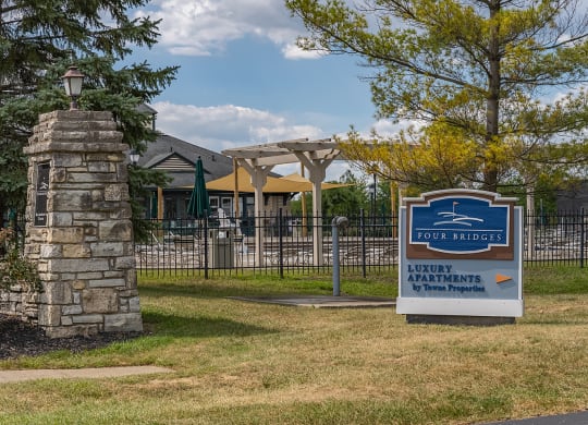 a sign in front of a gate with a house in the background at Four Bridges, Liberty Township, OH, 45044-8380