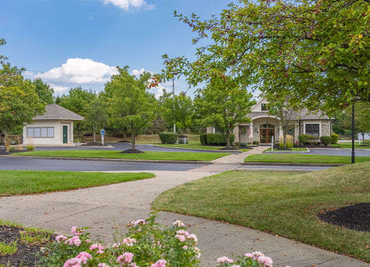 a street with houses and trees and a sidewalk at Four Bridges, Liberty Township, OH