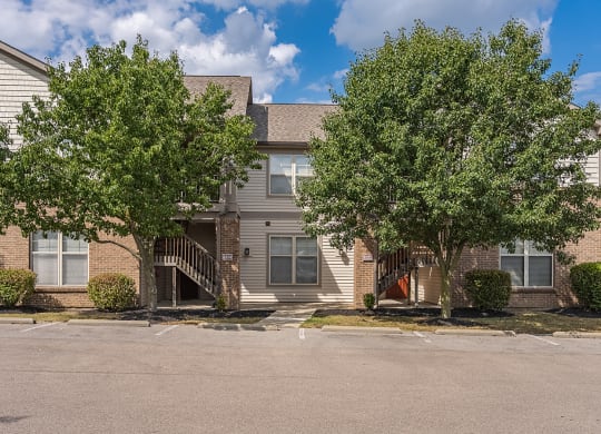 an apartment building with two trees in front of it at Four Bridges, Liberty Township