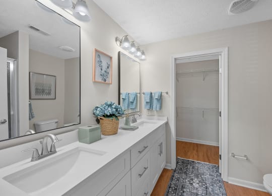 Bathroom with a sink and a mirror and a shower at Four Bridges, Liberty Township