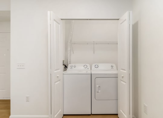 a washer and dryer in a room with white walls