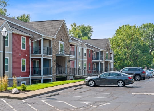 Row of townhouses with cars parked in a parking lot at Galbraith Pointe Apartments and Townhomes, Ohio