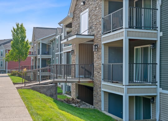 Apartment building with balconies and a sidewalk at Galbraith Pointe Apartments and Townhomes, Cincinnati, Ohio