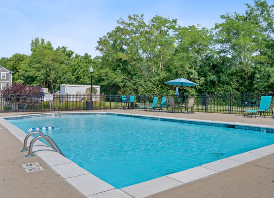 Swimming pool with blue chairs and a fence around it at Galbraith Pointe Apartments and Townhomes*, Ohio, 45231