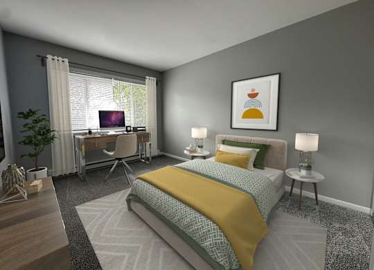 a bedroom with a bed and a desk with a computer