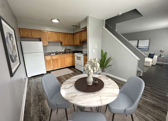 a kitchen and dining room with a table and chairs