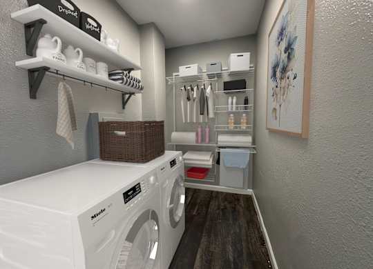 a laundry room with a washer and dryer and shelving and a closet