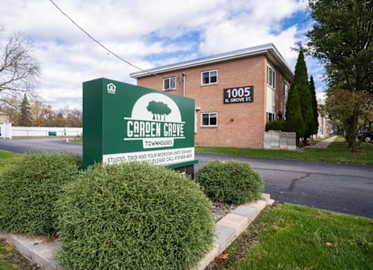 the sign for church hope apartments in front of a brick building