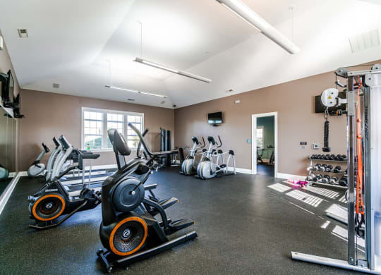 a gym with cardio equipment and weights on the floor at Grove City Summit Apartments, Grove City, OH