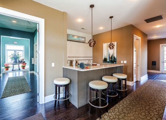 a kitchen with a bar and stools at Grove City Summit Apartments, Grove City, 43123