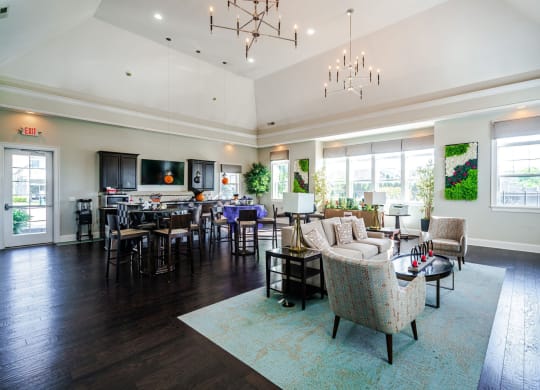 a large living room with couches and chairs and a dining room with a table at Grove City Summit Apartments, Grove City, Ohio