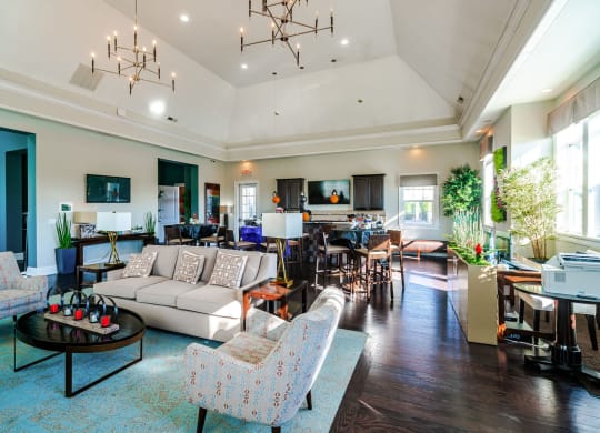 a spacious living room with couches and chairs and a dining room with a kitchen at Grove City Summit Apartments, Grove City, OH, 43123