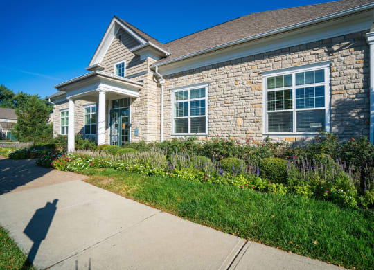 a stone house with a sidewalk in front of it at Grove City Summit Apartments, Ohio