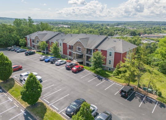 an aerial view of a parking lot and apartment buildings with cars parked  at Hilltop Apartments, Ohio, 45213-2638