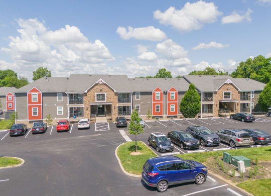 Parking lot in front of an apartment building with cars parked in front  at Hilltop Apartments, Cincinnati, 45213-2638