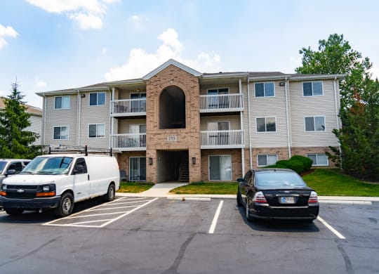 Apartment building with cars parked in a parking lot at Honey Creek, Greenwood, IN, 46143