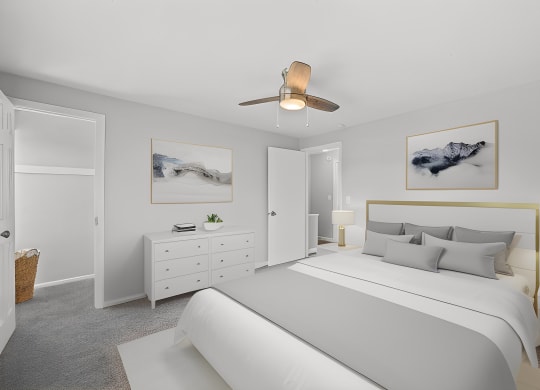 a white bedroom with a large bed and a ceiling fan at Huntley Ridge, Kettering