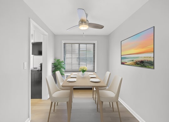 a dining room with a table and chairs and a ceiling fan at Huntley Ridge, Kettering