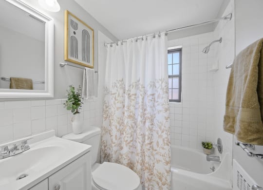 a bathroom with a shower curtain and a sink and a toilet at Huntley Ridge, Kettering, OH, 45419