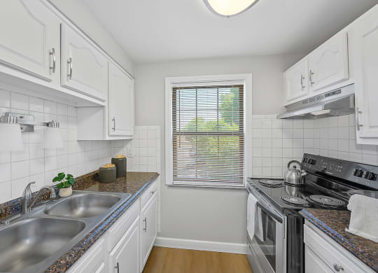 a kitchen with a sink and a stove and a window at Huntley Ridge, Kettering, OH, 45419